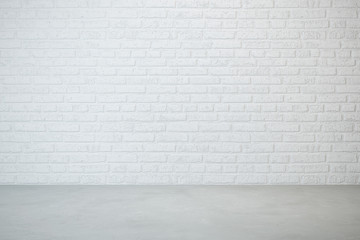empty room with brick wall and concrete floor