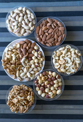 Healthy food. Nuts mix assortment on texture top view. Collection of different legumes for background image close up nuts, pistachios, almond, cashew nuts, peanut, walnut. image