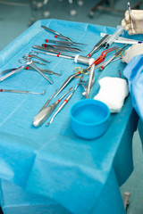 Close up of doctor hands during surgery in operation room. Sterile surgery instruments used in a...