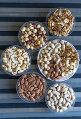 Healthy food. Nuts mix assortment on texture top view. Collection of different legumes for background image close up nuts, pistachios, almond, cashew nuts, peanut, walnut. image