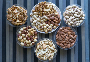 Healthy food. Nuts mix assortment on texture top view. Collection of different legumes for background image close up nuts, pistachios, almond, cashew nuts, peanut, walnut. image
