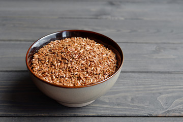 flax seeds in bowl on table background