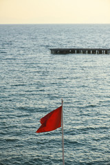 Red warning flag on beach