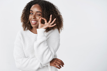 Waist-up shot of relaxed and chill good-looking dark-skinned woman in warm sweater got winter...