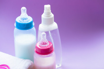 Newborn baby story. Towels and children's toys, scissors, baby bottle, nipple, hairbrush on white background