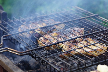 Big pieces of meat steaks are cooked on the grill