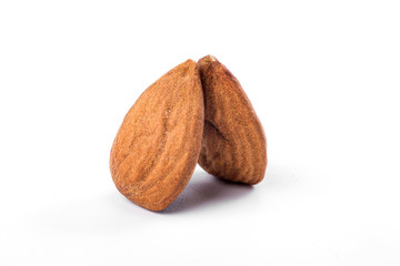 Two almonds on a white background, close up.
