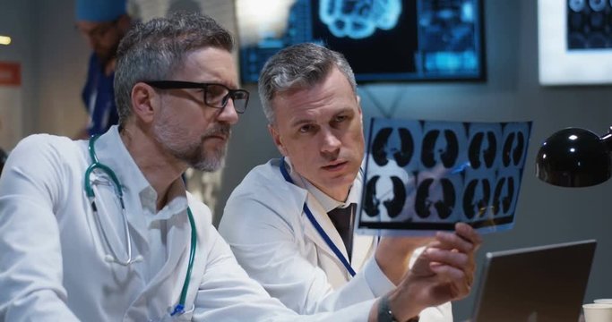 Doctors analyzing MRI scan results