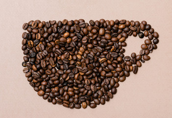 cup of coffee lined from coffee beans on a paper background