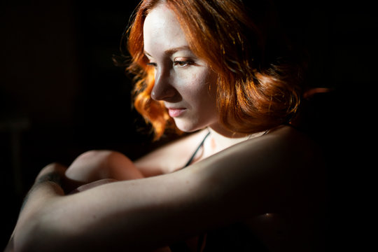 Pensive redhead woman sitting