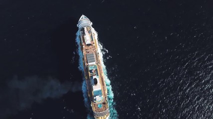 Aerial top view of luxury large cruise ship sailing full speed on open water, luxury vacation concept. Stock. Large Cruise ship sailing across The Mediterranean sea.
