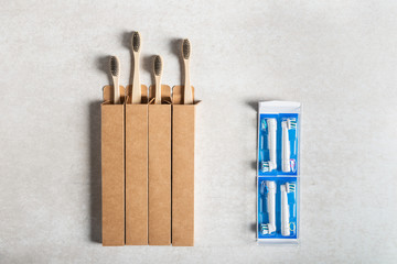 Zero waste or NO plastic concept. Plastic toothbrush heads vs bamboo toothbrushes. Flatlay, top...