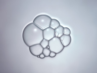Bulles de savon en macrophotographie, bulles de taille variable connectées entre elles sur un fond neutre
