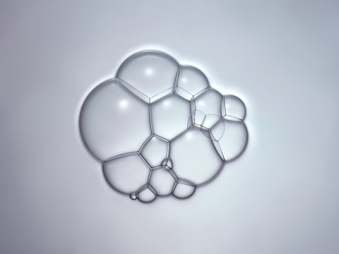 Bulles de savon en macrophotographie, bulles de taille variable connect&eacute;es entre elles sur un fond neutre