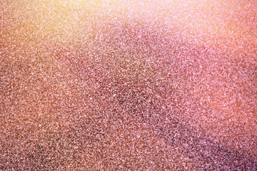 Bright Background image of glitter texture in pink and gold shades.