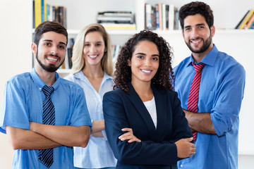 Latin businesswoman with group of women and businessmen