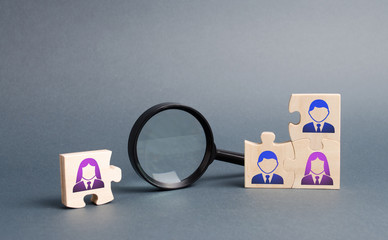 Unsorted team puzzle and magnifying glass. Search, recruitment staff, hiring leader. Lack of...