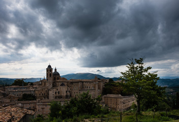 Fototapeta na wymiar Panoramic view of the ducal palace of Urbino in central Italy with a dramatic sky