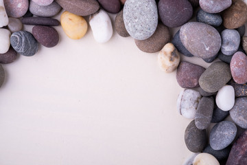 Fototapeta na wymiar Varied pebbles on white background top view