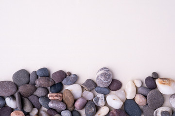 Varied pebbles on white background top view