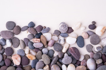 Varied pebbles on white background top view