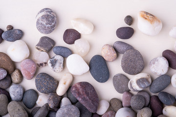 Fototapeta na wymiar Varied pebbles on white background top view