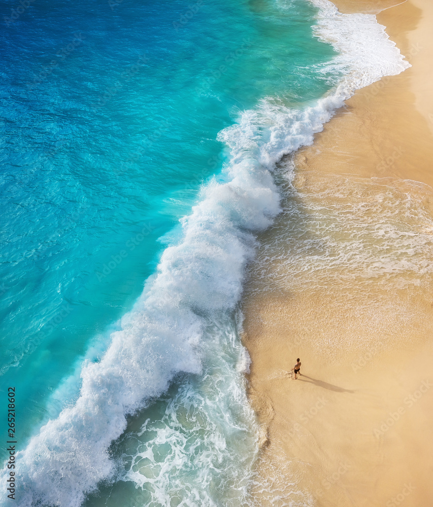 Wall mural view of a man on the beach on bali, indonesia. vacation and adventure. top view from drone at beach,