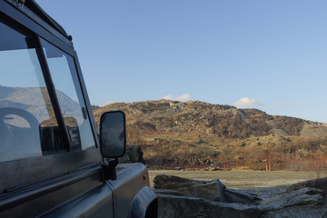 Antique off-road vehicle with views of the Lake District hills