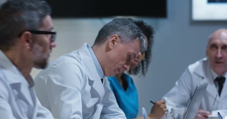 Doctors having a meeting - Powered by Adobe