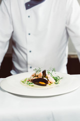 Professional chef prepares food in a restaurant.