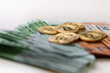 Euro banknotes and bitcoin coins used.