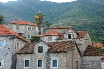 Fototapeta na wymiar Beautiful shot of old Mediterranean stone houses under the grassy mountain.