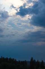 Landscape with dramatic light - beautiful golden sunset with saturated sky and clouds.