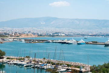 Fototapeta na wymiar Small sailing boats and yachts docked at port of Piraeus, Greece