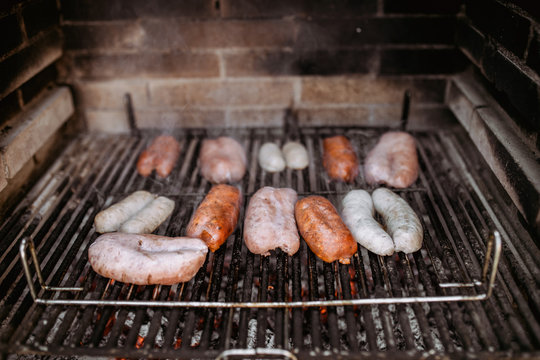 cooking sausages and chorizo in barbecue