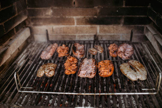 cooking sausages and chorizo in barbecue