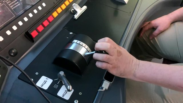 Train Driver Hand On Thrust Lever Of Dashboard Controls In Cockpit Cabine.