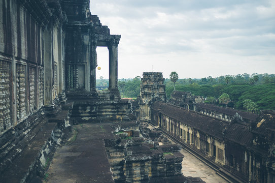 Shabby walls and terrace of amazing old temple on overcast day in jungle