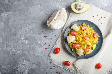 Fried pomelo with tomatoes and avocado on gray concrete background. Top view, copy space.