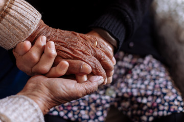 Detail of the wrinkled hands of an elderly couple