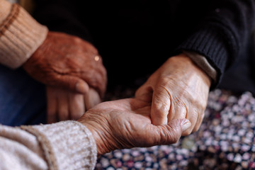 Detail of the wrinkled hands of an elderly couple