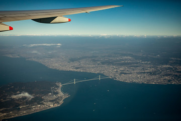 aerial view from plane window over Akashi-Kaikyo Bridge crossing osaka bay japan