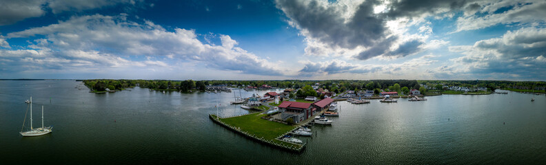Fototapeta na wymiar Aerial panorama of shipyard and lighthouse in St. Michaels harbor in Maryland in the Chesapeake Bay