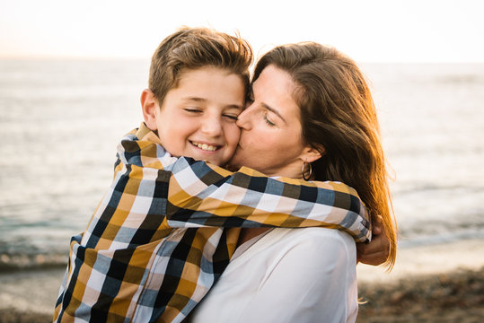 Middle Aged Woman With Her Son At Sea Shore Smiling And Hugging Each Other