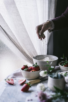 Crop woman preparing strawberry pastry