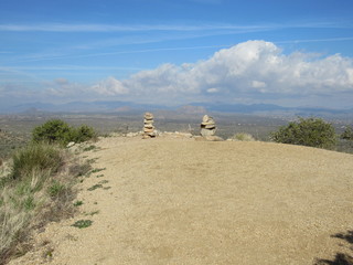 View of cairns, or stacks of rocks, on a mountain near Phoenix, Arizona, overlooking the town below