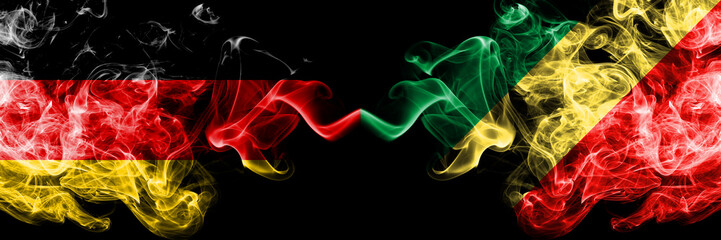 Germany vs Congo, Congolese smoky mystic flags placed side by side. Thick colored silky smoke flags of Deutschland and Congo, Congolese