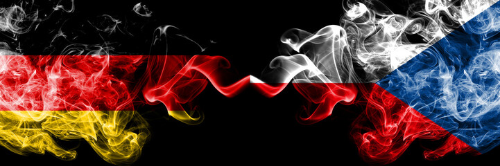 Germany vs Czech Republic smoky mystic flags placed side by side. Thick colored silky smoke flags of Deutschland and Czech Republic