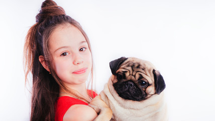 Little girl in a red dress and the Pug-dog isolated on a white background