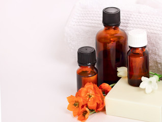 Spa still life. Aromatherapy, essential oil, orange flowers and bath products on white. Copy space